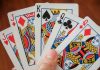 a hand holding a game card