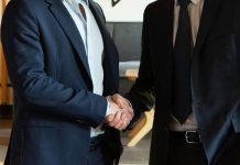 Clean Books, Faster Close: Why 2026 Buyers Walk From Messy Deals Two business partners shaking hands in agreement