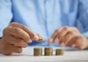 How Large Cap Mutual Funds Work: Risk, Returns and Investment Horizon Explained a person stacking coins on top of a table