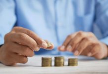 How Large Cap Mutual Funds Work: Risk, Returns and Investment Horizon Explained a person stacking coins on top of a table