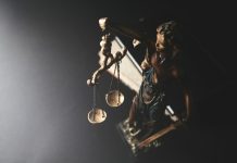 The 48-Hour Window That Can Shape a Criminal Case Statue of justice with scales on dark background