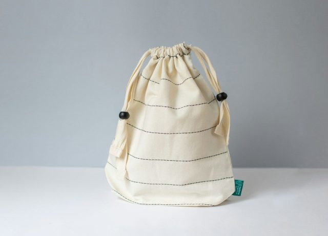 Photo by Yellow Cactus a white bag sitting on top of a white table