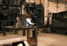 Practical Ways to Improve Safety Across Industrial Workplaces A man working on a piece of paper in a factory