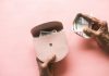brown leather hand bag on pink table