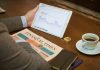 Navigating Debt, Hybrid, and Equity Mutual Funds: A Portfolio Guide for MF App Users a person sitting at a table with a tablet and a cup of coffee