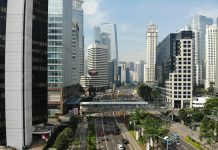 Essential Financial and Legal Considerations for Expanding a Business into Indonesia High-angle view of a multi-lane road with traffic and a pedestrian bridge in Jakarta