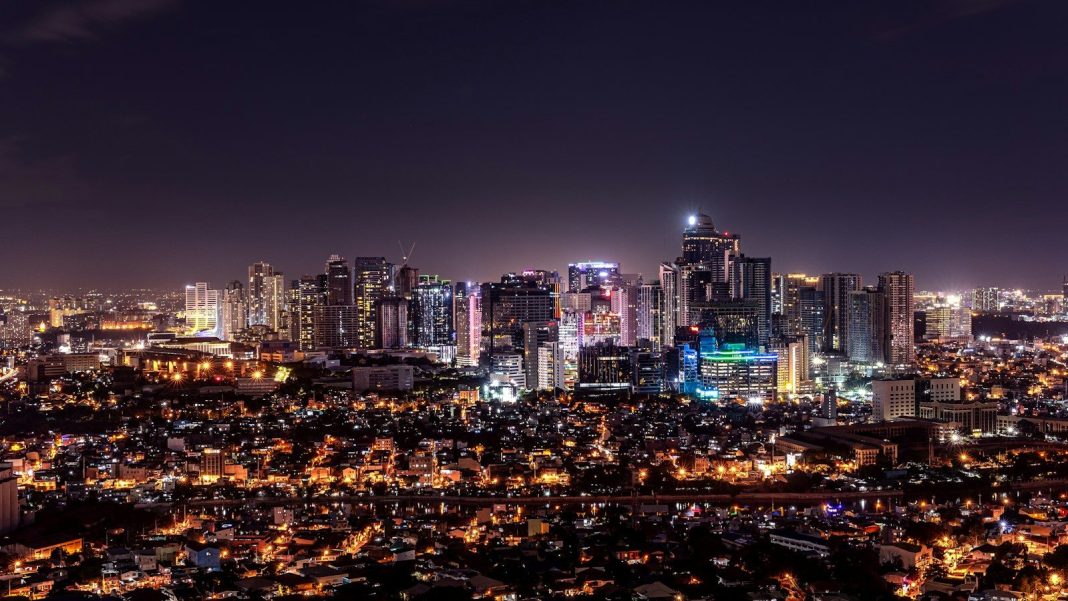 Photo by Sean Yoro city with high rise buildings during night time