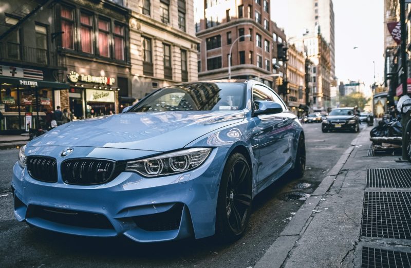 blue-bmw-coupe-parked-on-the-road-during-daytime
